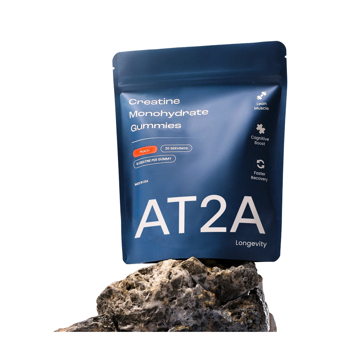 AT2A creatine monohydrate gummies pouch resting on a stone